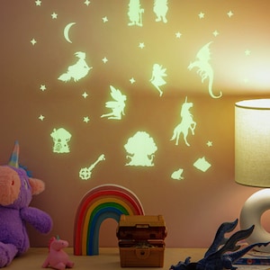 May include: Glow-in-the-dark wall decals featuring a whimsical fairy tale theme. The decals include a unicorn, a dragon, a fairy, a gnome, a tree, a moon, stars, and a key. The decals are perfect for adding a touch of magic to any child's room.