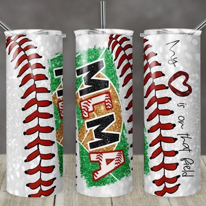 May include: Three white, glitter-covered tumblers with a baseball stitch design. The center tumbler has a green and gold baseball graphic with the word "MEMA". The right tumbler has the text "My ♥ is on that field".