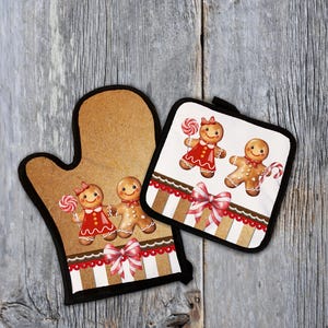 May include: A brown oven mitt and pot holder set with a gingerbread theme. The mitt and pot holder feature gingerbread people with red dresses and candy canes. The set has a black border and a red and white striped design.