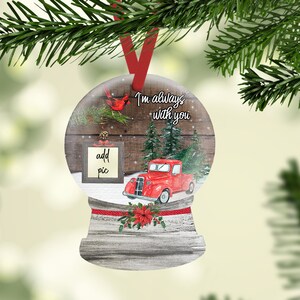 May include: A red truck with a Christmas tree in the back drives through a snowy winter scene. A cardinal sits on a branch in the background. The snow globe ornament has the text "I'm always with you" and a frame that says "add pic".