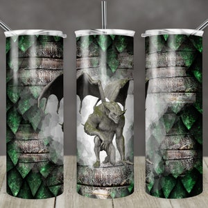 May include: A stainless steel tumbler with a green and gray design featuring a gargoyle with wings. The design has a wood grain texture.