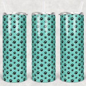 May include: Three stainless steel tumblers with a teal glitter background and black paw print pattern.