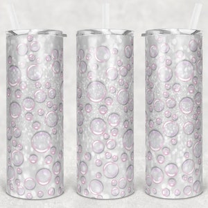 Puede incluir: Tres vasos de acero inoxidable con un diseño de purpurina blanca y rosa con un patrón de burbujas.