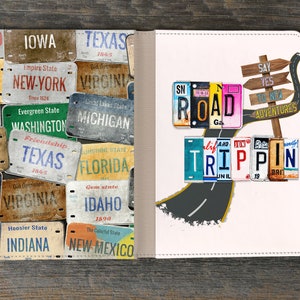 May include: A white leather notebook with a road trip theme. The front cover features a collage of vintage license plates spelling out "ROAD TRIPPIN". The back cover features a collage of vintage license plates with state names like "Texas", "Florida", and "New York".