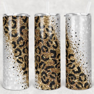 Pode incluir: Três copos de aço inoxidável com um design de glitter branco e dourado. O design de glitter apresenta um padrão de leopardo preto.