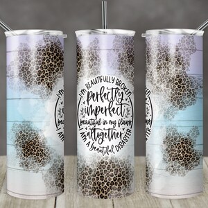 May include: A stainless steel tumbler with a white and blue watercolor background and a leopard print design. The tumbler has a quote that reads "I'm beautifully broken, perfectly imperfect, beautiful in my flaws, altogether a beautiful disaster".