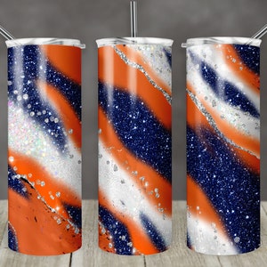 May include: Three stainless steel tumblers with a blue, white, and orange glitter swirl design. The tumblers have lids and straws.