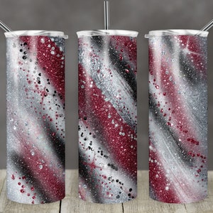 May include: Three stainless steel tumblers with a red, white, and black glitter design. The tumblers have a clear lid and a straw.