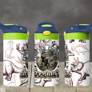 May include: A white water bottle with a blue and green lid, featuring a dinosaur theme. The bottle is decorated with various dinosaur illustrations and the text "Forever Chasing Dinosaurs".