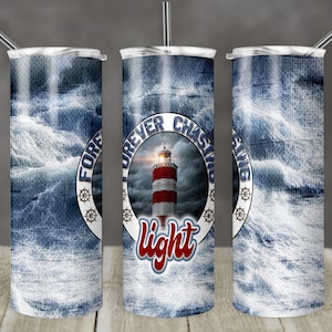 May include: A stainless steel tumbler with a blue and white design featuring a lighthouse and waves. The tumbler has the text "Forever Chasing Light" on it.