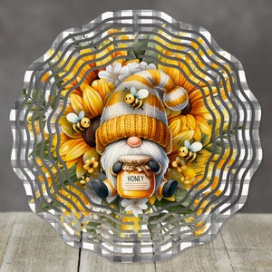 May include: A yellow and white gnome with a striped hat is surrounded by sunflowers and bees. The gnome is holding a jar of honey that says "Honey".