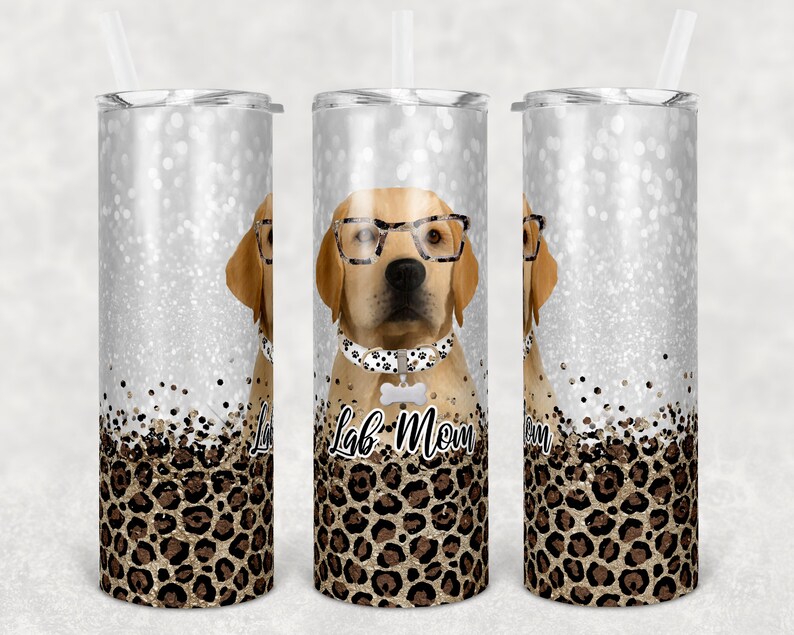 May include: Three stainless steel tumblers with a glitter background and a leopard print design. The center tumbler features a cartoon Labrador Retriever wearing glasses and a bow tie with the text "Lab Mom" on the bottom.