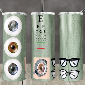 May include: Three stainless steel tumblers with a green woodgrain design. The first tumbler features three cartoon eyes. The second tumbler features an eye chart with the letters E, FP, TOZ, LPED, PECFD, EDFCZP, FELOPZD, DEFFOTEC, LEPROLC, and  a close-up of an eye being examined. The third tumbler features two pairs of eyeglasses.