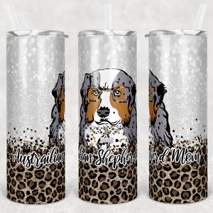 May include: Three stainless steel tumblers with a silver glitter background and a leopard print design. The center tumbler features a cartoon Australian Shepherd dog wearing glasses and the text "Australian Shepherd Mom".