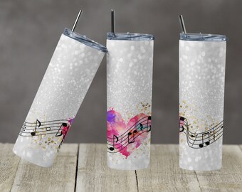Puede incluir: Tres vasos de plata con purpurina con un diseño de corazón de acuarela y notas musicales. El corazón es rosa, azul y morado. Las notas son negras y doradas.