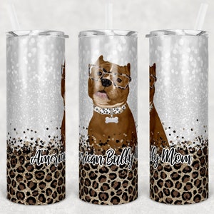 May include: Three stainless steel tumblers with a silver glitter background and a leopard print design. The center tumbler features a brown and white American Bully dog wearing glasses and a bone-shaped tag. The text "American Bully Mom" is printed on the tumblers.