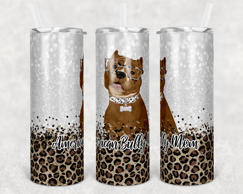 May include: Three stainless steel tumblers with a silver glitter background and a leopard print design. The center tumbler features a brown and white American Bully dog wearing glasses and a bone-shaped tag. The text "American Bully Mom" is printed on the tumblers.