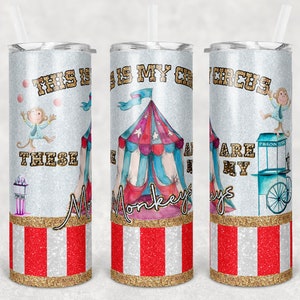 May include: Three stainless steel tumblers with a glitter finish and a circus theme. The tumblers feature a red and white striped design, a circus tent, monkeys, and the text "This is my circus, these monkeys are my clowns".