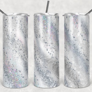 May include: Three stainless steel tumblers with a white and silver glitter swirl design. The tumblers have lids and straws.