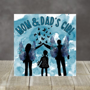 May include: A blue watercolor background with silhouettes of two angels with wings and a small child in the center. The text "MOM & DAD'S GIRL" is at the top of the image. The text "I USED TO BE THEIR ANGEL NOW THEY ARE MINE" is in the center of the image.