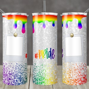 May include: Three stainless steel tumblers with a silver glitter background and a rainbow drip design. The tumblers have a white photo frame with a gold button. The middle tumbler has the text "#pride" in black.