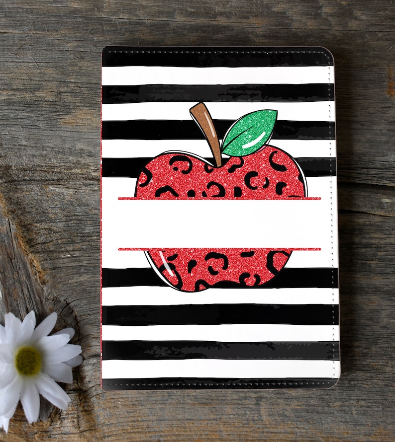 May include: Black and white striped notebook cover with a red apple with black leopard print and green leaves. The apple has a white space for personalization.