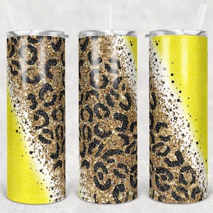Pode incluir: Três copos amarelos e dourados com glitter com um design de estampa de leopardo preto. Os copos estão alinhados em uma fila.