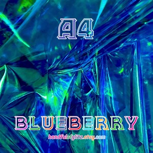 Close-up of Blueberry dichroic foil, glowing with cool indigo and violet shimmer. Crinkled Blueberry foil sheet with vivid shimmer, often used in ASMR videos. Flashy blue mylar with spectacular green and yellow reflections. Iridescent color shifting film for resin crafts, cosplay, asmr and more.