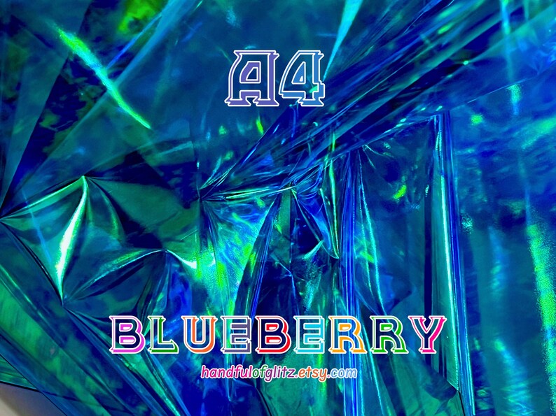 Close-up of Blueberry dichroic foil, glowing with cool indigo and violet shimmer. Crinkled Blueberry foil sheet with vivid shimmer, often used in ASMR videos. Flashy blue mylar with spectacular green and yellow reflections. Iridescent color shifting film for resin crafts, cosplay, asmr and more.
