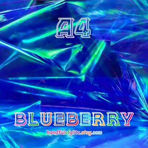 Close-up of Blueberry dichroic foil, glowing with cool indigo and violet shimmer. Crinkled Blueberry foil sheet with vivid flashes, often used in ASMR videos.