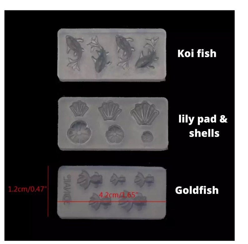 May include: Three silicone molds for crafting. The top mold features four koi fish designs. The middle mold has three lily pad and shell designs. The bottom mold has four goldfish designs. The molds are labeled "Koi fish", "lily pad & shells", and "Goldfish". The molds measure 1.2 inches by 4.2 inches.