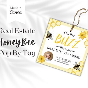 May include: A yellow and white real estate tag with a honeybee design. The tag says "Get the Buzz on the current Real Estate Market" and includes contact information for Olivia Moore.