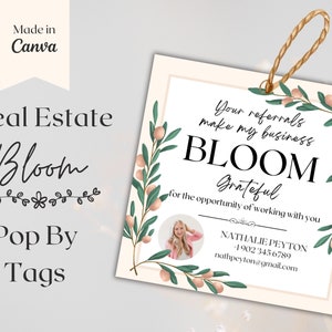 May include: A white tag with green floral borders and pink flowers. The text reads "Your referrals make my business BLOOM Grateful for the opportunity of working with you." Below the text is a photo of a woman and contact information for Nathalie Peyton.