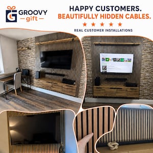 May include: A wall-mounted media console and television setup featuring vertical wood slat paneling against a stone-textured wall. The display includes text reading HAPPY CUSTOMERS. BEAUTIFULLY HIDDEN CABLES. REAL CUSTOMER INSTALLATIONS.