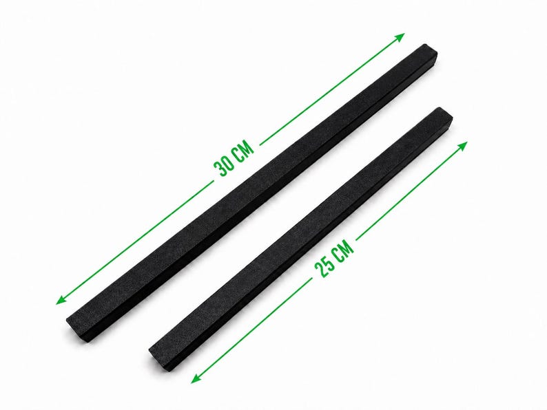 May include: Two black rectangular bars with a textured finish. One bar measures 30 cm in length, and the other bar measures 25 cm in length. The bars are positioned diagonally against a white background with green dimension lines and text.