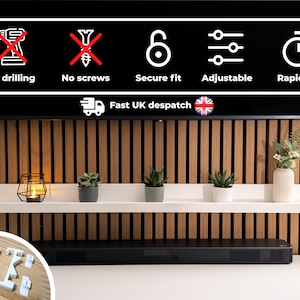 May include: White floating shelf with three potted plants and a candle holder. The shelf is mounted on a wood wall with a black TV above it. The text "Fast UK despatch" is visible on the TV screen.