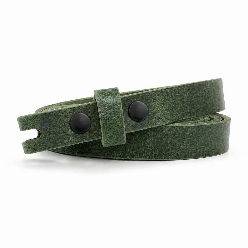 May include: A forest green leather strap coiled into a circular shape. The strap features a textured surface and is secured with two matte black metal snap buttons on a single loop, with a notched end visible on the left side of the strap.