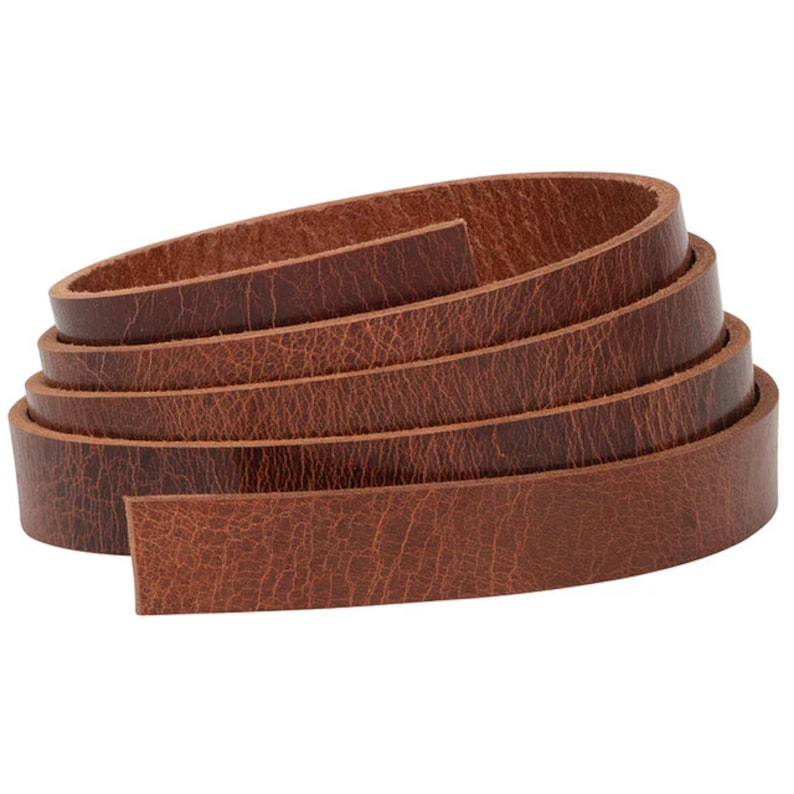 May include: A roll of brown leather straps, perfect for crafting projects. The leather is a natural brown color with a textured surface.