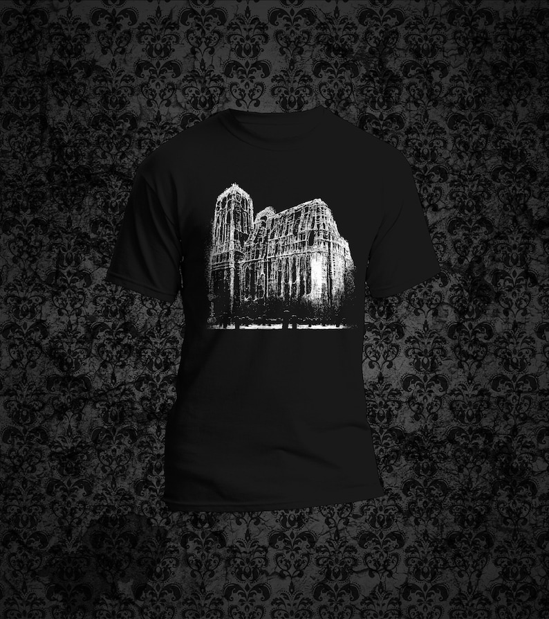 May include: Black t-shirt with a white graphic print of a building with a gothic architecture style.