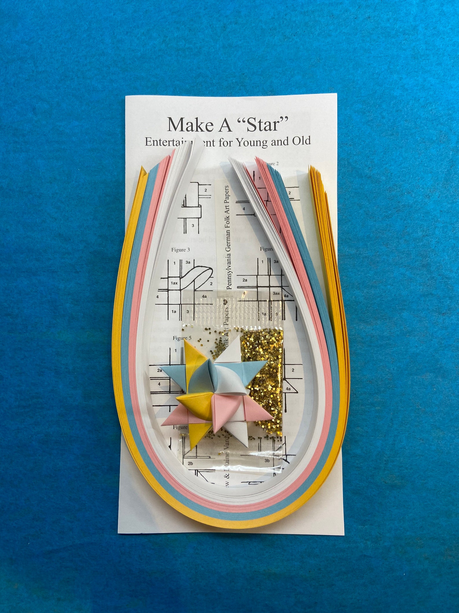 Make a Star Kit - 100 Strips - Multicolor. Includes sample star, instructions and glitter pack. Makes 25 stars