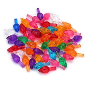 May include: Assortment of colorful Christmas light bulb covers in various shades of red, orange, yellow, green, blue, purple, and clear. The covers are shaped like a flame and have a textured surface.