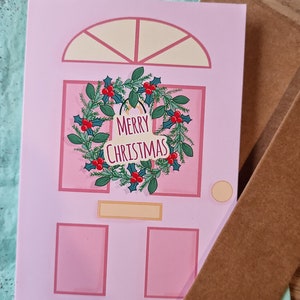 Tarjeta de puerta rosa de corona de Navidad