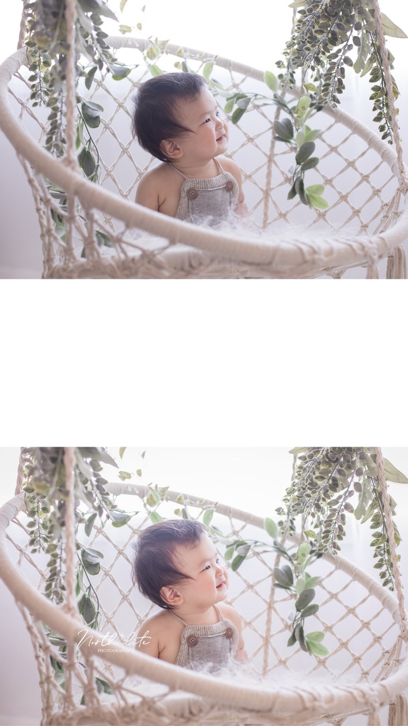 May include: A baby wearing a gray jumpsuit sits in a white macrame swing chair with green leafy vines hanging around the chair.