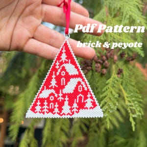 May include: Red and white beaded Christmas tree ornament in a triangular shape, with a festive winter scene design. The ornament is suspended by a red ribbon. The text "Pdf Pattern brick & peyote" is visible.