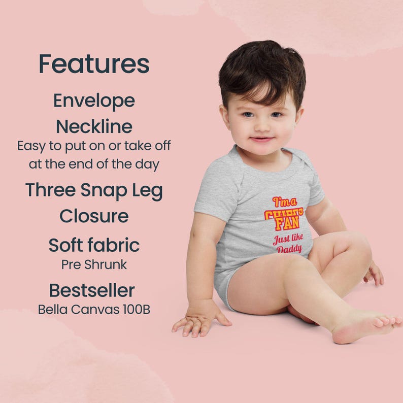 May include: A gray baby onesie with a red and yellow graphic that says "I'm a CUBS FAN Just like Daddy". The onesie has an envelope neckline and three snap leg closure. The onesie is made of soft fabric and is pre-shrunk. It is a bestseller from Bella Canvas.