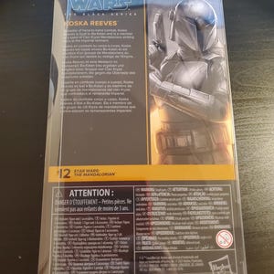 May include: A Star Wars: The Mandalorian action figure of Koska Reeves, a Mandalorian warrior, in a black and gray suit with a blue helmet. The figure is holding a blaster rifle. The packaging is black and yellow with the Star Wars logo and the character's name.