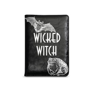 May include: Black leather journal with a white bat and frog design and the text "WICKED WITCH" printed on the front.