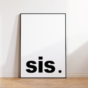 May include: A framed art print with a white background and the word "sis." in bold, black letters. The artwork is displayed against a white wall, with a wooden floor visible below. The frame is black.