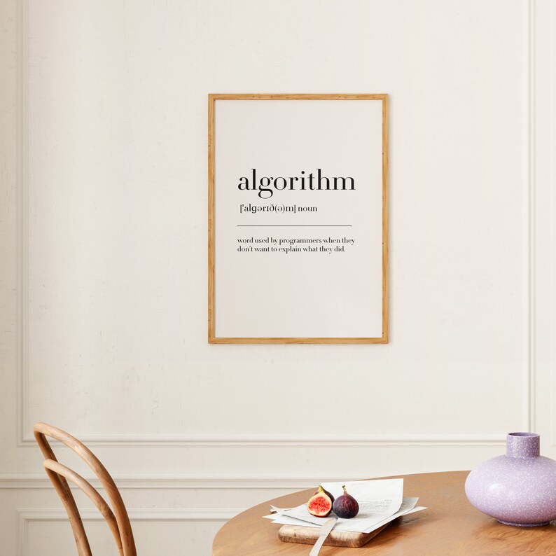 May include: A framed print with a definition of the word "algorithm" in black text on a white background. The definition reads: "word used by programmers when they don't want to explain what they did."