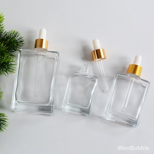 1oz 30ml 50ml 100ml Bottiglie contagocce in vetro quadrato in vetro trasparente con tappo in oro, bottiglia di olio essenziale per erbe di siero di profumo per la cura della pelle fai-da-te, commercio all'ingrosso